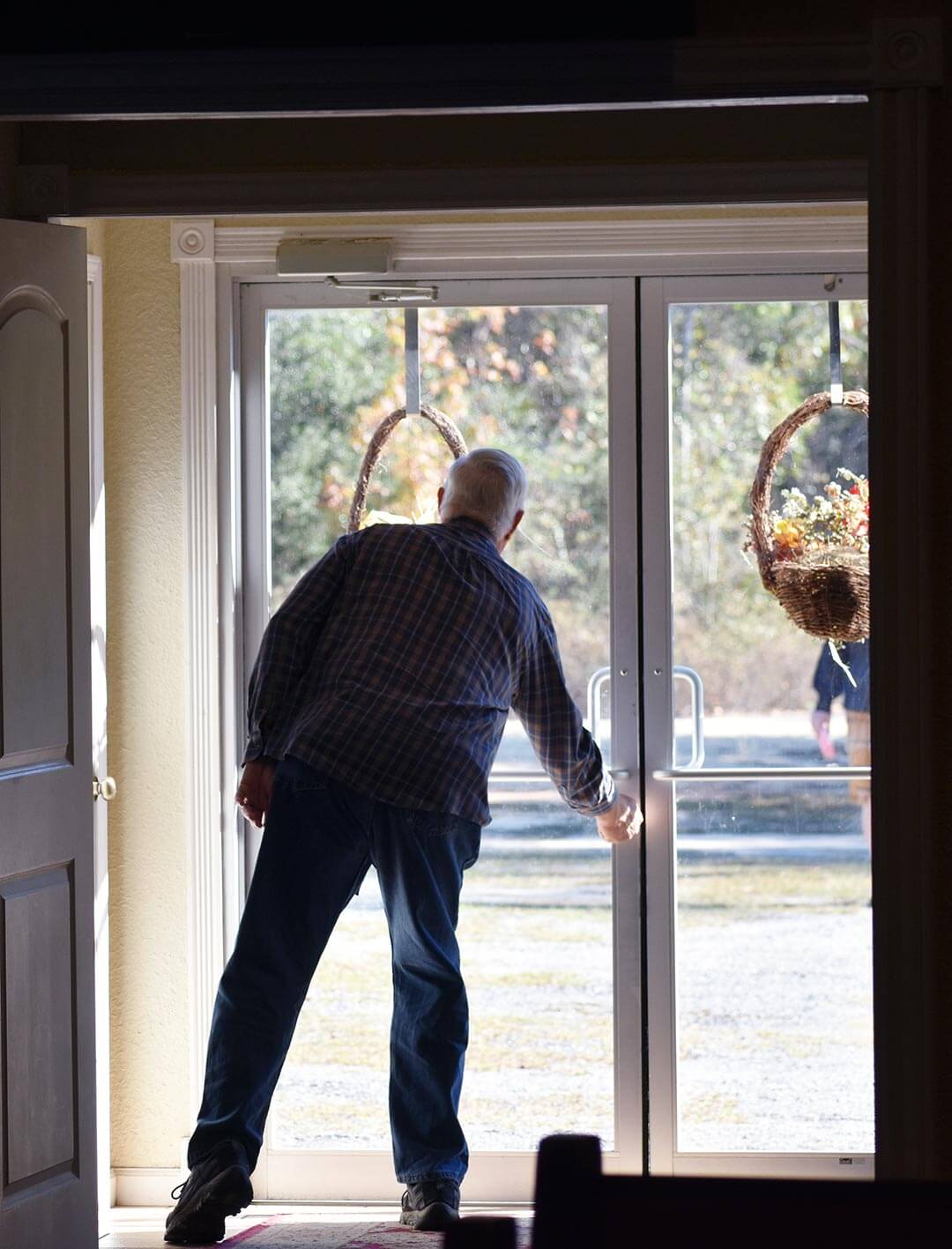 Pentecostal church member preparing to open the door for approaching family.